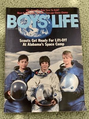 Cover of the Boys' Life magazine featuring three boys in astronaut suits, with a background image of Earth and the headline about scouts preparing for space camp.